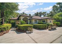 Charming single-story home with manicured landscaping, mature trees, and a spacious front yard and driveway at 35350 County Road 439, Eustis, FL 32726