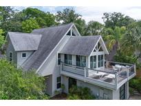 Charming home featuring a spacious deck perfect for entertaining, surrounded by lush greenery at 421 W 10Th Ave, Mount Dora, FL 32757