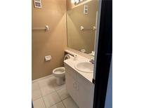 This bathroom features a large mirror and a clean, white vanity with storage at 6205 Peregrine Ct, Orlando, FL 32819