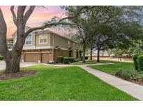 Charming townhome featuring a two-car garage, lush lawn, and inviting landscaping at 866 Ashworth Overlook Dr # B, Apopka, FL 32712
