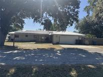 Charming single story brick home featuring a metal roof and solar panels at 916 Kentucky St, Haines City, FL 33844