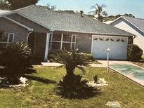 Charming single-story home with a well-manicured lawn and attached one-car garage at 1060 Davenport Dr, The Villages, FL 32162
