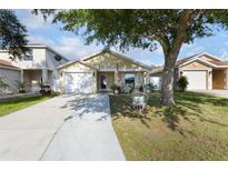Charming single-story home featuring a well-maintained yard and inviting front porch with swing at 12430 Ne 52Nd Loop, Oxford, FL 34484
