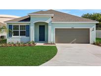 Charming single-story home with a well-manicured lawn and attached one car garage at 2860 Supermarine Rd, Tavares, FL 32778
