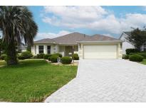 Well-maintained single-Gathering home with a paved driveway and lush landscaping at 3177 Williams Rd, The Villages, FL 32162