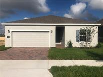 Charming single-story home featuring a two-car garage, landscaped yard and neutral color palette at 4102 Penelope Ave, Lake Wales, FL 33859