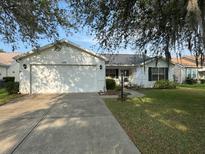 Charming single-story home featuring a two-car garage and well-maintained front yard at 529 Del Mar Dr, Lady Lake, FL 32159