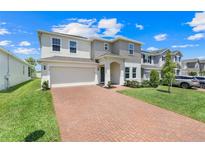 Charming two-story home features a brick driveway and a two-car garage at 678 Blackstone St, Minneola, FL 34715