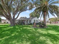 Charming single-story home featuring well-manicured lawn and mature trees for beautiful curb appeal at 1202 Del Toro Dr, Lady Lake, FL 32159