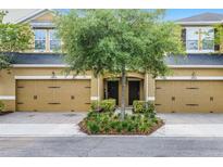 Two-story townhome featuring a symmetrical facade, dual garage doors, and a well-maintained front garden at 14430 Desert Haven St # 4302, Windermere, FL 34786