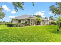 Charming single-story home with lush landscaping and well-maintained lawn at 36455 Clara St, Eustis, FL 32736
