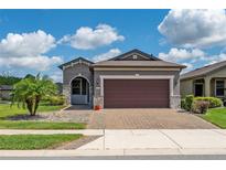 Charming single-story home with a well-manicured lawn, paver driveway, and a two-car garage at 503 Vigo St, Davenport, FL 33837