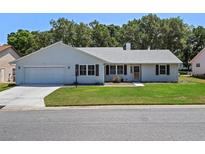 Charming single-story home with a well-manicured lawn and classic curb appeal at 5712 Connors St, Leesburg, FL 34748