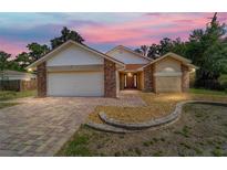 Charming single-story home boasting a brick and stucco exterior with a neatly paved driveway at 6259 Se 120Th Pl, Belleview, FL 34420