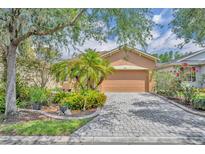 Charming single-story home with a well-manicured lawn and a paver driveway at 684 Grand Canal Dr, Kissimmee, FL 34759