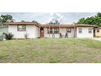 Charming single-story home with a cozy covered porch and well-maintained front lawn at 800 Jefferis Ct, Eustis, FL 32726