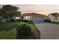 Charming single-story home features a well-manicured lawn, two-car garage, and inviting curb appeal at 802 San Salvador Dr, The Villages, FL 32159