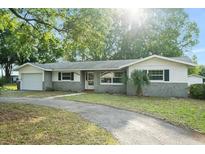 Charming single-story home featuring a well-maintained front yard and a paved driveway at 9782 County Road 121, Wildwood, FL 34785