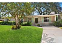 Charming single-story home featuring a lush green lawn, mature tree, and inviting front entrance at 1416 Abigail Dr, Apopka, FL 32703