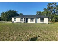 Charming single-story home with a well-manicured lawn, contrasting trim, and a classic design at 2 Pine Terrace Way, Ocala, FL 34472