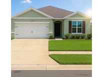 Inviting single-story home featuring a two-car garage, a well-manicured lawn, and charming architectural details at 2106 Elio Ridge Dr, Zellwood, FL 32798