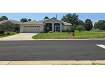 Charming single-story home with well-maintained lawn and two car garage at 5300 Treasure View Way, Leesburg, FL 34748