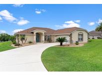 Charming home with a well-manicured lawn, and appealing landscaping at 5400 Saddleback Ct, Lady Lake, FL 32159
