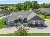 Stunning single-story home featuring a well-manicured lawn and a neutral color scheme exterior at 563 Dowling Cir, Lady Lake, FL 32159