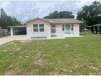 Charming single-story home with a well-maintained front yard and covered carport at 640 Mansfield Rd, Tavares, FL 32778