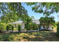 Charming single-story home featuring mature landscaping and manicured front yard at 11442 Beggs Ct, Clermont, FL 34711