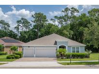 Charming single-story home with a two-car garage and well-maintained landscaping at 179 Birchmont Dr, Deland, FL 32724