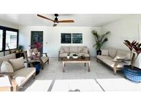 Bright living area with comfortable seating, ceiling fan, and neutral color scheme at 2227 S Spring Garden Ave, Deland, FL 32720