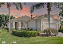 Charming single-Gathering home featuring a two-car garage, manicured lawn and lush landscaping at 2602 Stargrass Cir, Clermont, FL 34715