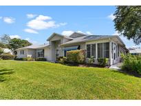 Well-maintained home featuring a spacious lawn and attractive landscaping at 26030 Newcombe Cir, Leesburg, FL 34748