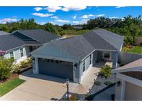 Charming single Gathering home featuring manicured front yard and a two-car garage at 4451 Elijah Loop, The Villages, FL 32163