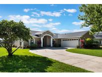 Charming single-story home with a well-manicured lawn, inviting entrance, and a spacious three-car garage at 4835 Calasans Ave, St Cloud, FL 34771