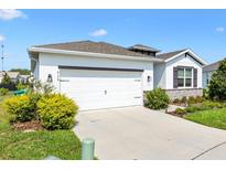 Charming single-story home with a two-car garage and well-manicured landscaping at 8178 Penrose Pl, Wildwood, FL 34785