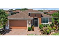 Charming single-story home showcasing a well-manicured lawn and beautiful landscaping at 453 Treviso Dr, Poinciana, FL 34759