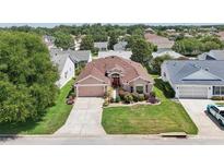 Charming single-story home with well-manicured lawn, mature landscaping, and inviting curb appeal at 17108 Se 76Th Creekside Cir, The Villages, FL 32162