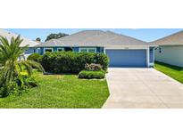 Charming single-story home features a well-manicured lawn and an attached two-car garage at 2160 Biller Cir, The Villages, FL 32163