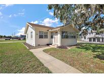 Charming single-story home with a well-maintained lawn and inviting walkway at 30 E Key Ave, Eustis, FL 32726