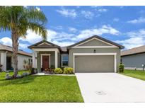 Charming single-story home with well-maintained lawn, colorful landscaping and neutral color palette at 3060 Neverland Dr, New Smyrna Beach, FL 32168