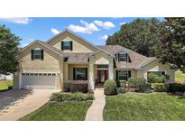 Charming single-Gathering home boasting a well-manicured lawn and two car garage at 397 Anderson Dr, Tavares, FL 32778