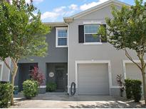 Inviting two-story townhome featuring a one-car garage and a charming front door with a 'Welcome' sign at 5333 Loblolly Ln, Wildwood, FL 34785
