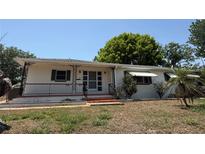Charming single-story home with a cozy front porch and well-maintained lawn at 603 W Seminole Ave, Eustis, FL 32726