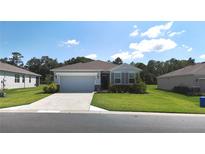 Charming one-story home featuring a two-car garage, well-maintained lawn, and inviting curb appeal at 6203 Sw 93Rd Loop, Ocala, FL 34476