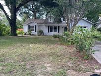 Charming single-story home features a classic design and mature trees in a lush front yard at 825 Mary Frank Ct, Mount Dora, FL 32757