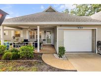 Charming single-story home with a welcoming front porch and attached one car garage at 8712 Sw 92Nd Pl # D, Ocala, FL 34481