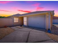 Charming single-story home featuring an attached two-car garage, and a well-maintained lawn at 1202 Fernando Ln, The Villages, FL 32159