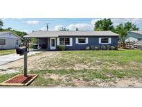Charming single-story home featuring a gray exterior, metal roof, and a well-maintained front yard at 1406 Hope Ct, Tavares, FL 32778